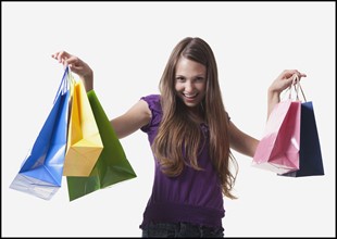 Teenage girl holding shopping bags. Photo : Mike Kemp
