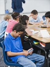 Student texting in classroom.