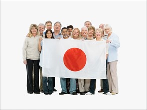 Group of people holding a Japanese flag. Photo : momentimages