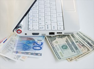 Money tucked underneath laptop. Photo : Jamie Grill