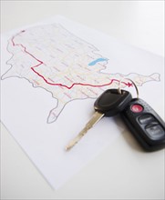 Car keys beside map of planned road trip. Photo : Jamie Grill