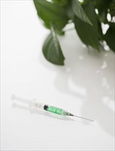 Syringe filled with green liquid. Photo : Jamie Grill