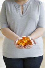 Woman holding several bottles of prescription medication.