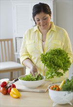 Woman preparing a salad.