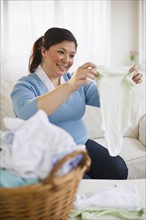 Overweight woman folding clothes.