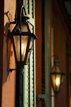 Lanterns on wall of building in French Quarter of New Orleans.