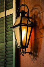 Lantern on wall of building in French Quarter of New Orleans.
