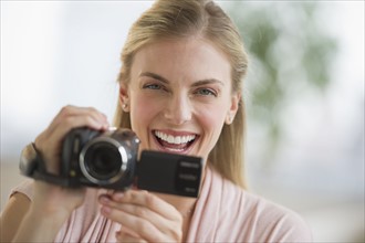 Woman laughing while taking a video.
