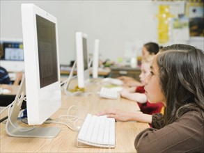 Children working at computers in classroom.