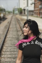 Woman standing on railroad tracks. Photo : Stewart Cohen