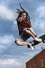 Teenage boy doing skateboard jump. Photo : Stewart Cohen