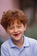 Cute young red headed boy missing his front teeth. Photo : Rob Lewine
