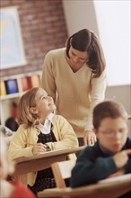 Elementary school student talking to teacher. Photo : Rob Lewine