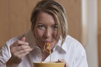 Woman eating spaghetti. Photo : Dan Bannister