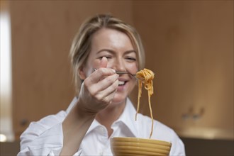Woman eating spaghetti. Photo : Dan Bannister