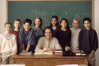 Elementary school students standing behind teacher. Photo : Rob Lewine