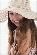Smiling long haired woman wearing a straw hat. Photo : Mike Kemp