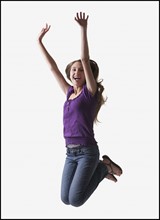Teenage girl jumping for joy. Photo : Mike Kemp