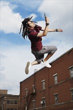 Teenage boy jumping in air. Photo : Stewart Cohen