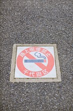 Japanese no smoking sign on sidewalk. Photo : Lucas Lenci Photo