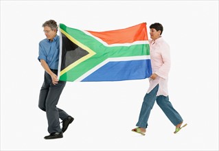 Two people carrying the South African flag. Photo : momentimages
