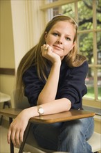 Teenage girl sitting at school desk. Photo : Stewart Cohen