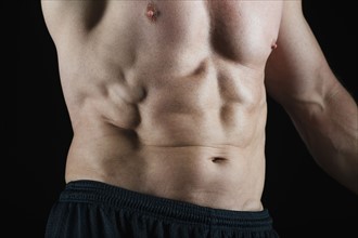 Abs of muscular man. Photo : Daniel Grill