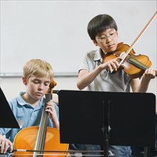 Elementary school students playing instruments in music class.