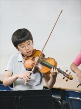 Elementary school students playing instruments in music class.