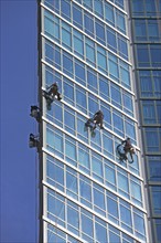 Window washers cleaning windows on skyscraper. Photo : fotog