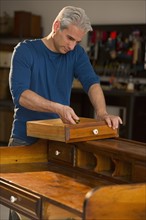 Craftsman fixing a piece of furniture.