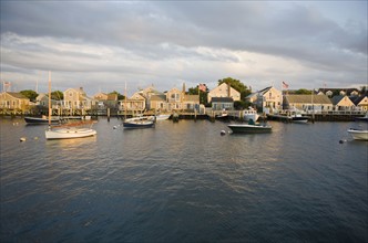 Boats in harbor with village in background. Photo : Chris Hackett