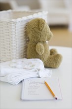 Notebook beside baby items.