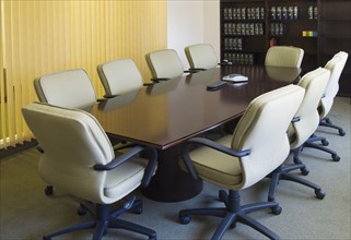 Desk and chairs in conference room.