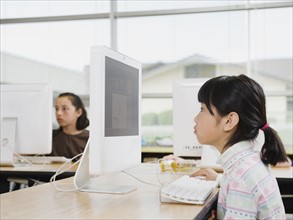 Students working on computers in classroom.