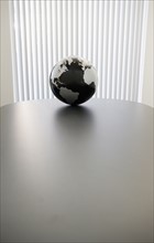 Globe on conference room table.