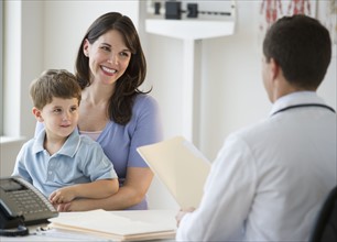 Doctor talking to woman and her son.