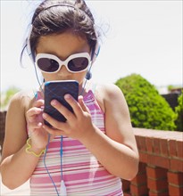Young girl texting.