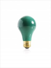 Green incandescent light bulb. Photo. David Arky