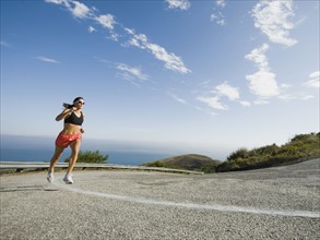 Woman running on a road in Malibu.