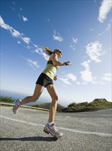 Woman running on a road in Malibu.