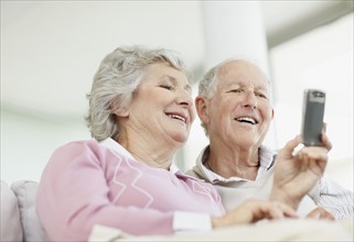 Senior couple reading text message. Photo. momentimages