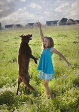Young girl playing with her dog. Photo : Mike Kemp