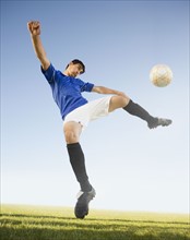 Soccer player kicking ball. Photo. Mike Kemp