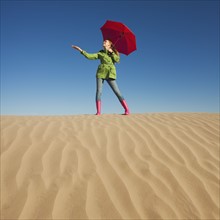Woman waiting for rain in the desert. Photo : Mike Kemp