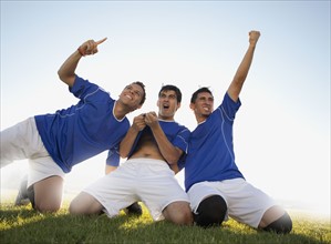 Three happy soccer players. Photo. Mike Kemp