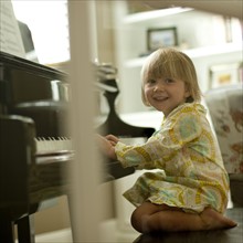 Young girl playing piano. Photo. Tim Pannell