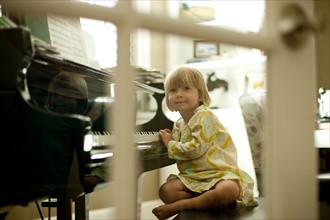Young girl playing piano. Photo. Tim Pannell