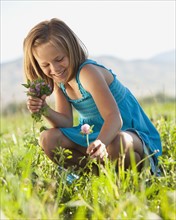 Young girl picking clover. Photo. Mike Kemp