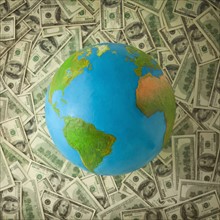 Globe on top of money. Photo : Mike Kemp